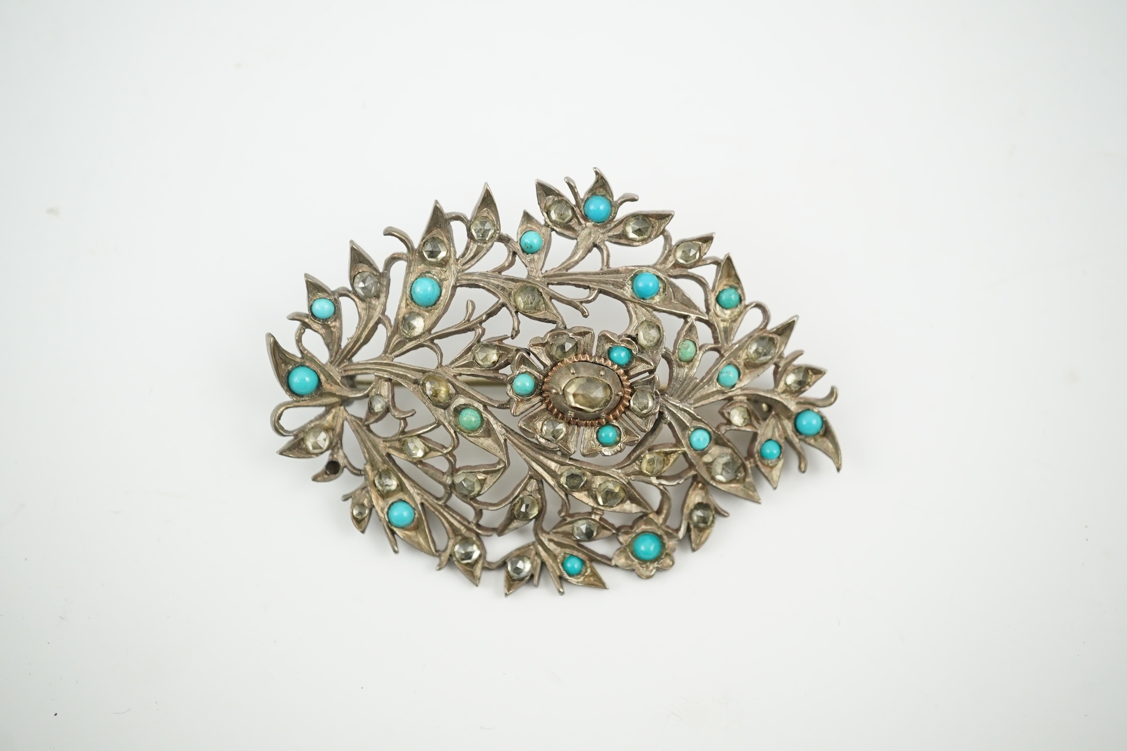 An Indian yellow and white metal, turquoise and simulated diamond set leaf brooch, 60mm. Condition - fair